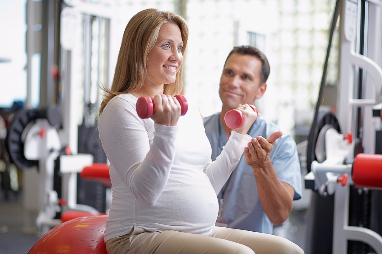 Physical Therapist with Pregnant Woman Patient --- Image by © Sean Justice/Corbis
