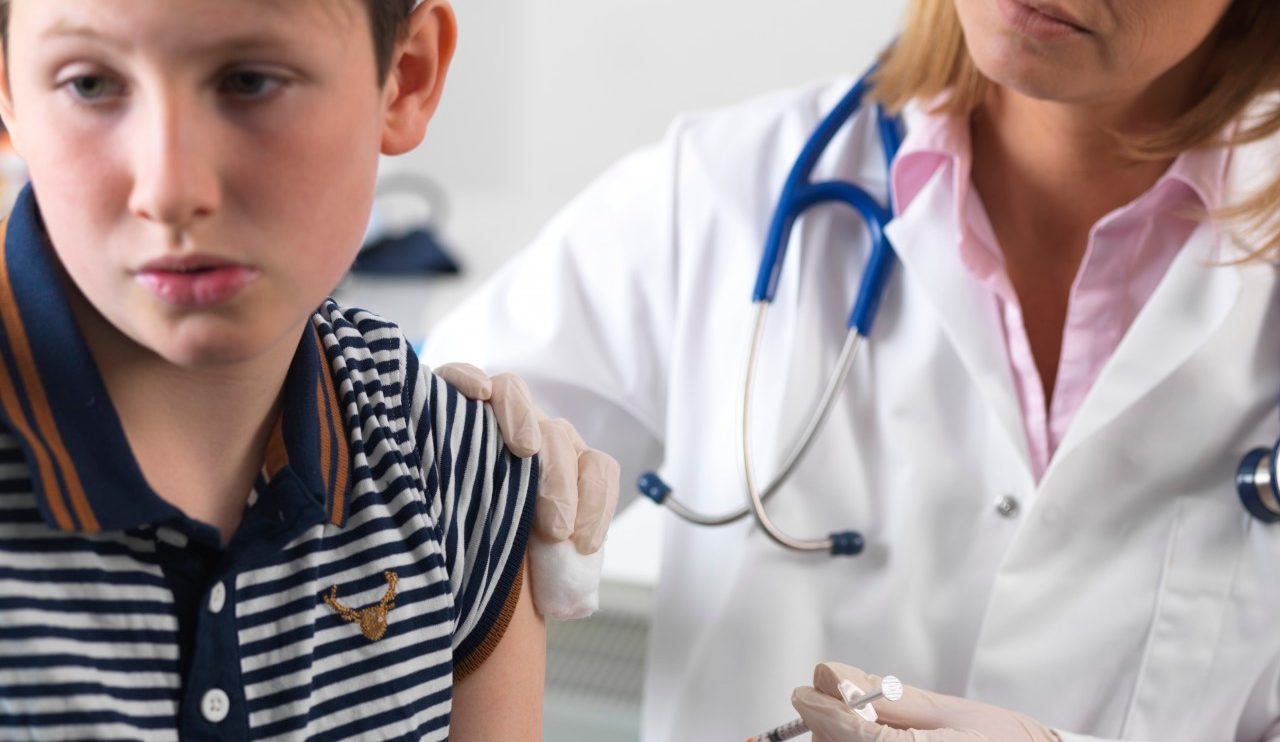 28 May 2015 --- Doctor injecting 10 year old boy a drug in a clinic. --- Image by © TEK IMAGE/Science Photo Library/Corbis