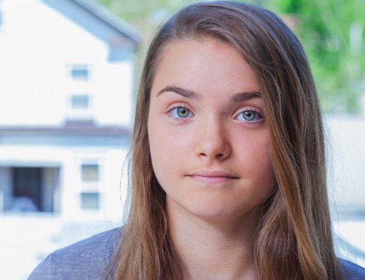 Connecticut, USA --- Portrait of a teenage girl in front of a house; Connecticut, United States of America --- Image by © Peter Glass/Design Pics/Corbis