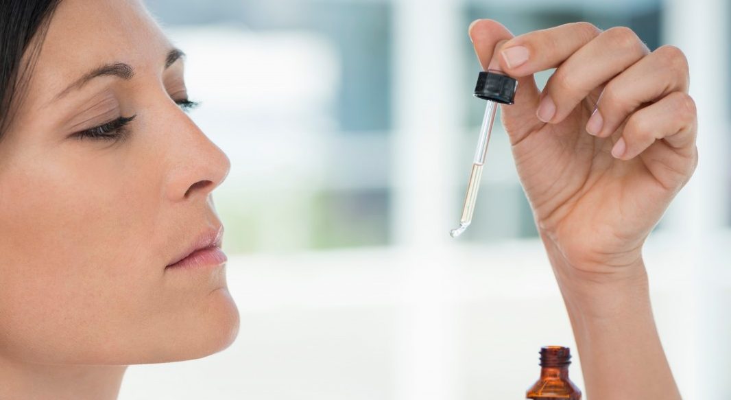 South Africa --- Close-up of a woman taking homeopathic medicine --- Image by © Eric Audras/Onoky/Corbis