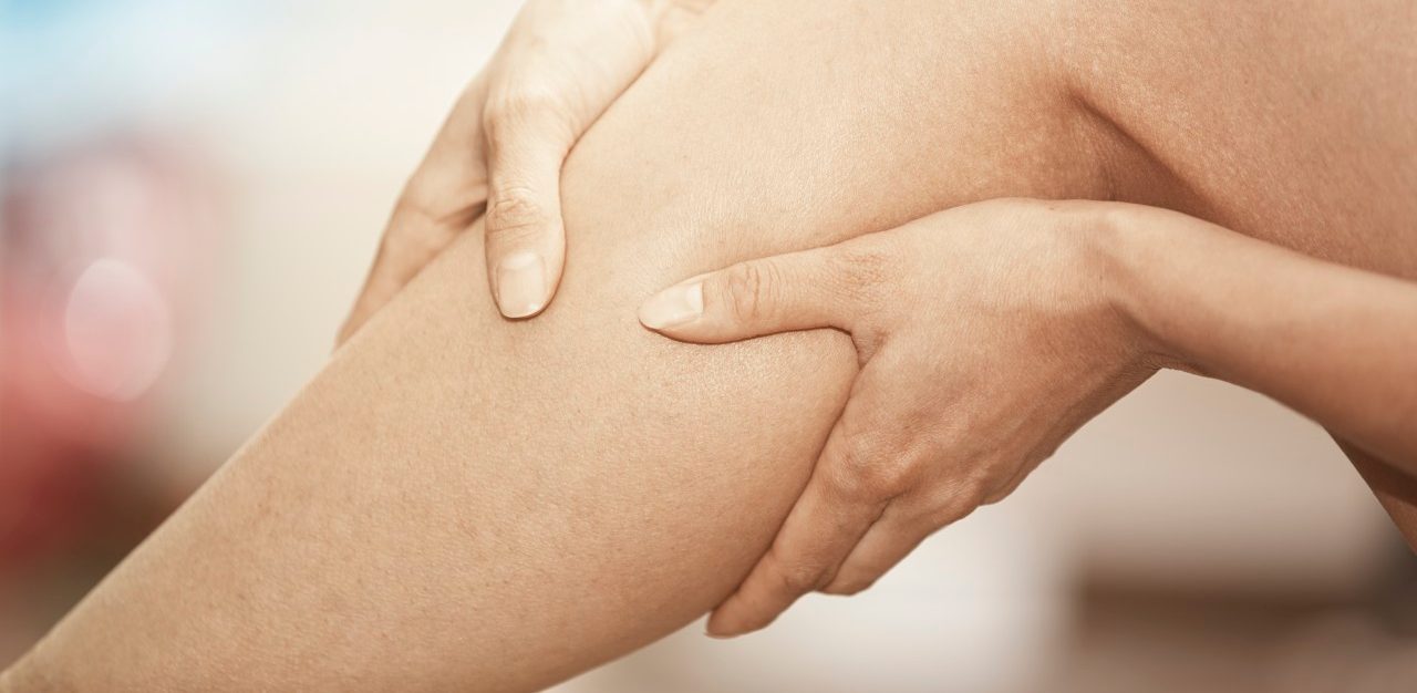 15 Feb 2015 --- Woman gripping her injured leg --- Image by © Arman Zhenikeyev/Corbis