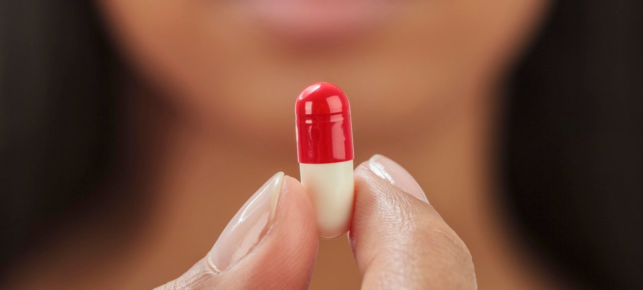 24 Sep 2012 --- Close up of mixed race woman holding medication capsule --- Image by © GP Kidd/Blend Images/Corbis