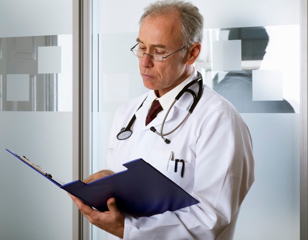 0042-11-30T00:00:00.000Z Doctor reading a chart --- Image by © David Sutherland/Corbis