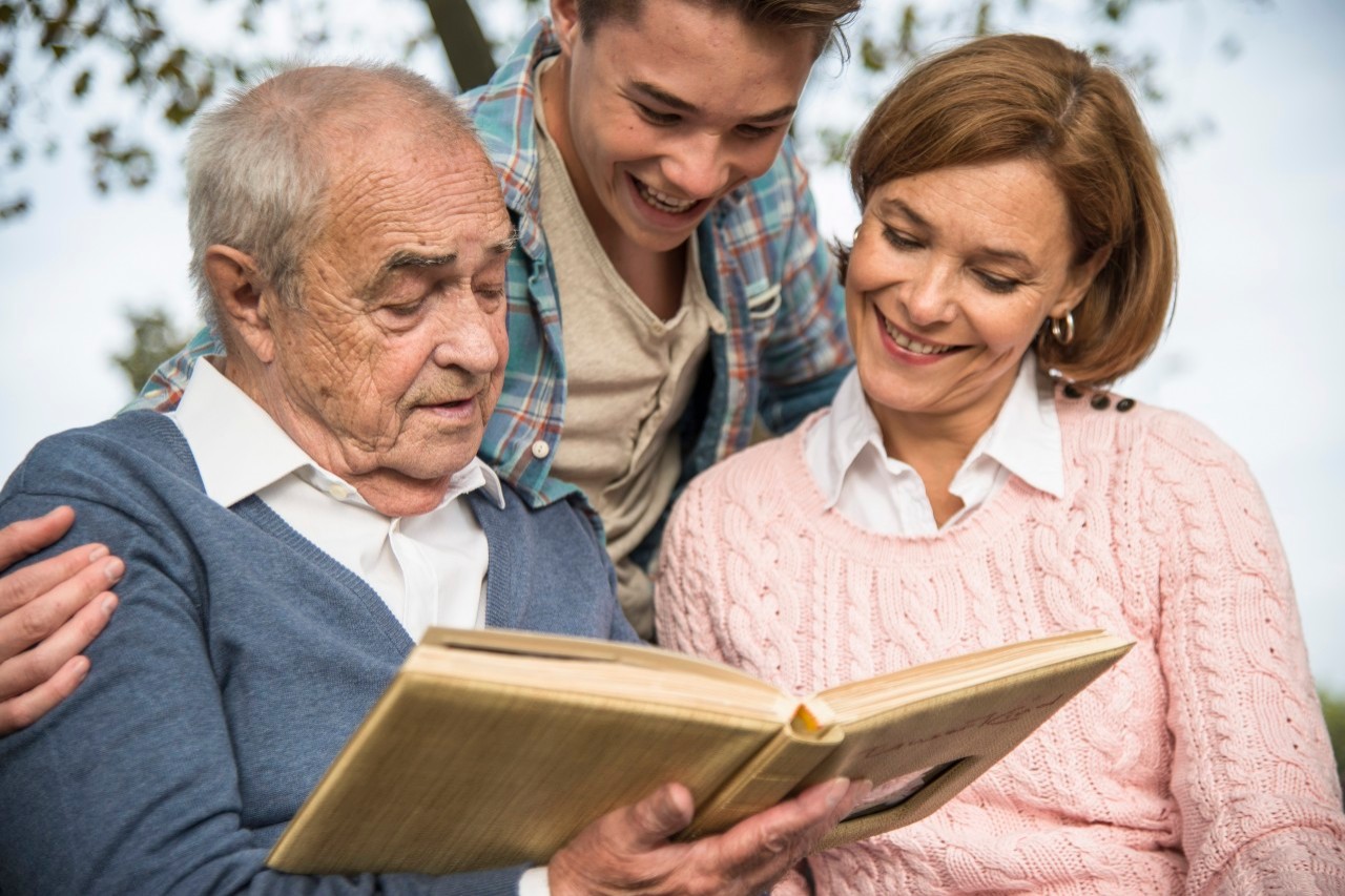 31 Oct 2014 --- Senior man with grandson and daughter looking at photo album --- Image by © Uwe Umstätter/Westend61/Corbis