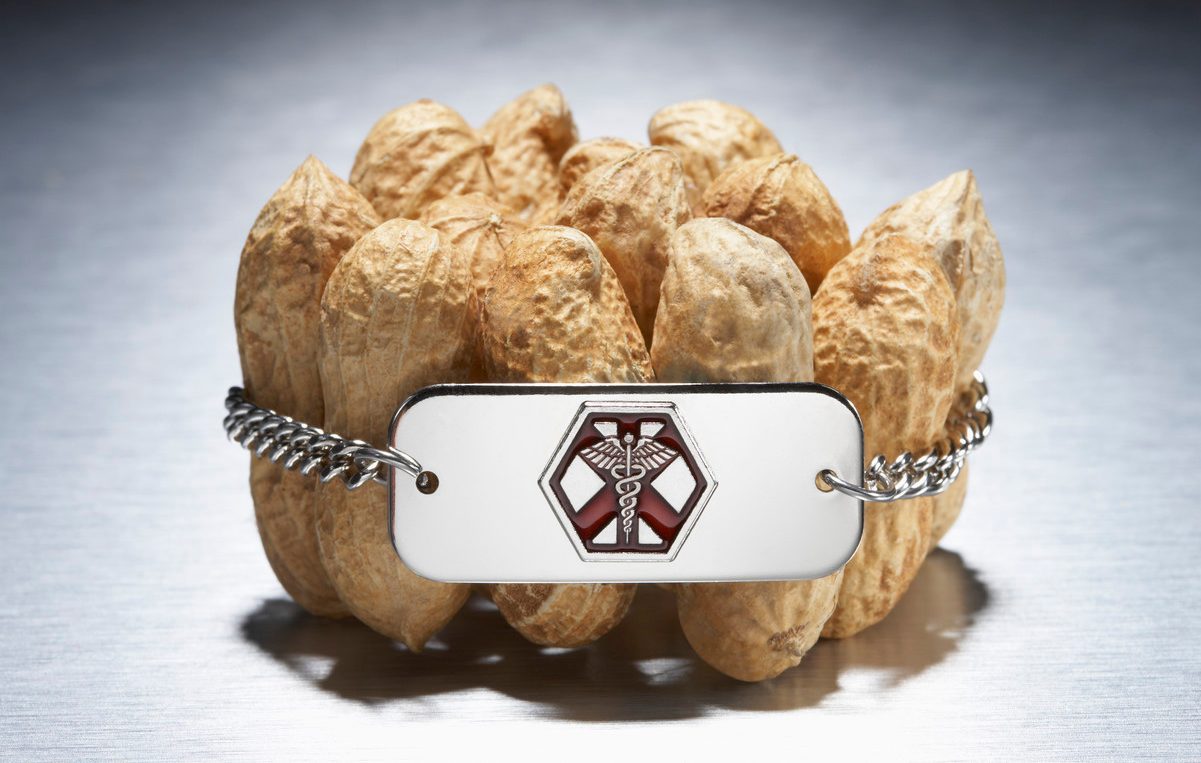 Medical alert bracelet around peanuts --- Image by © Peter Reali/Corbis