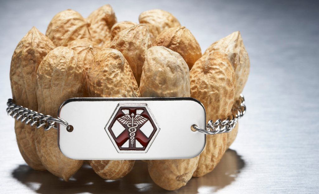 Medical alert bracelet around peanuts --- Image by © Peter Reali/Corbis