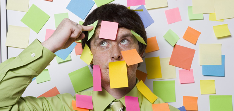 Male office worker covered with sticky notes --- Image by © Big Cheese Photo/Corbis