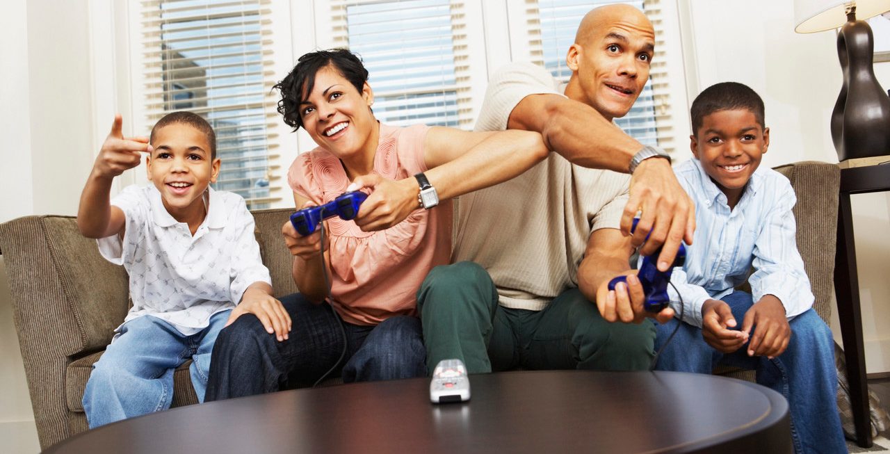 Family Playing Video Games --- Image by © Artiga Photo/Corbis