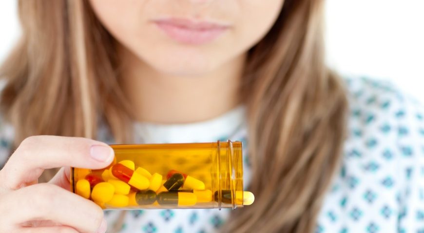 Close up of female patient taking pills --- Image by © Wavebreak Media Ltd/Veer/Corbis