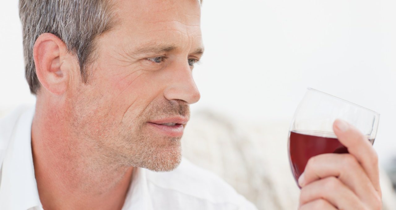 Handsome Man Drinking Some Red Wine --- Image by © Wavebreak Media Ltd./Corbis
