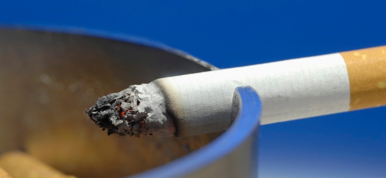 Cigarette on ashtray, close up --- Image by © Claudia Rehm/Westend61/Corbis