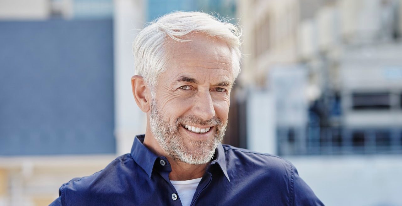 17 Jan 2015 --- Middle-aged man is looking forward, while standing on a roof-deck. --- Image by © Roger Richter/Corbis