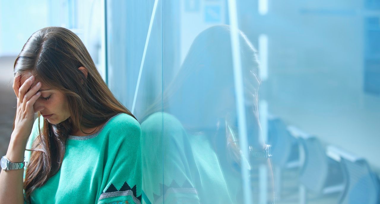 0042-11-30T00:00:00.000Z 25 Apr 2014 --- Mid adult businesswoman leaning against glass wall in office with hand on face --- Image by © Ghislain & Marie David de Lossy/Corbis