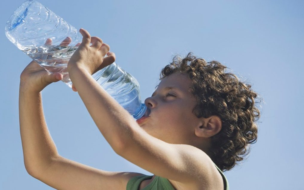 0042-11-30T00:00:00.000Z Low angle of young boy drinking water --- Image by © Steve Sparrow/cultura/Corbis