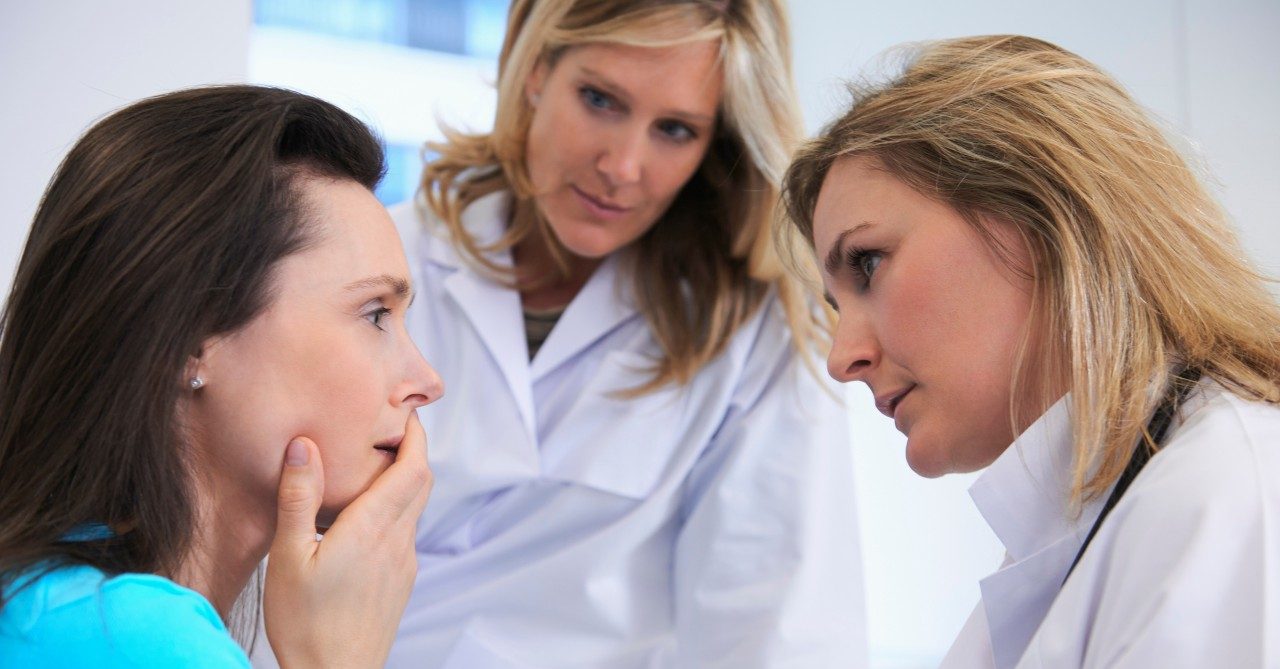 0042-11-30T00:00:00.000Z Doctors comforting female patient --- Image by © Ghislain & Marie David de Lossy/Corbis