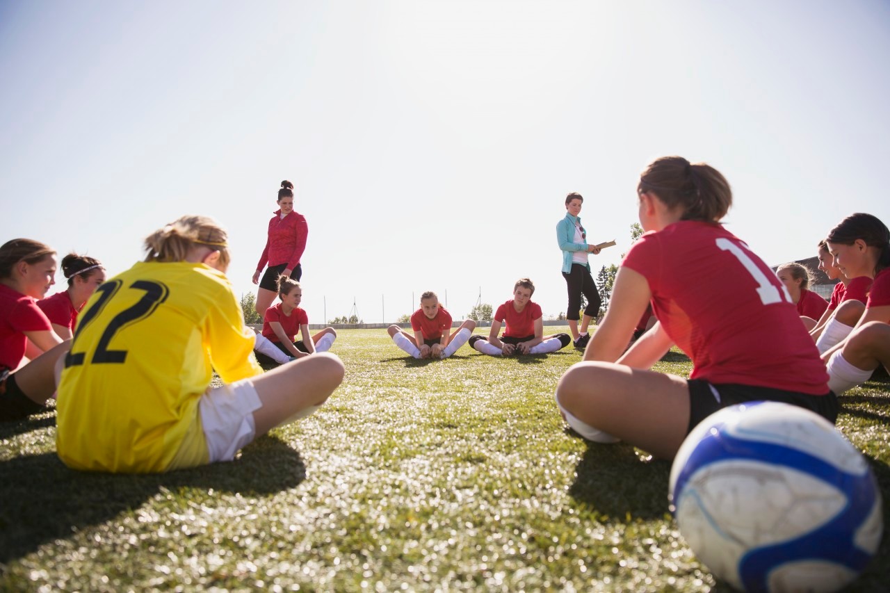 21 Sep 2012 --- Girls soccer team stretching before game. --- Image by © Hero Images/Corbis