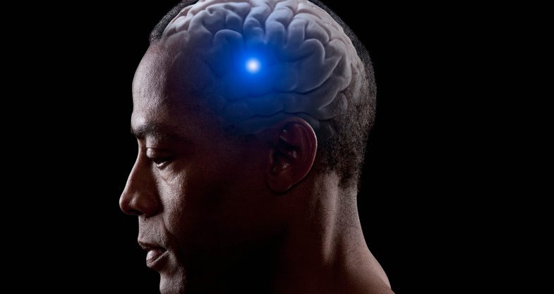 BLD076159 Blue light shining from brain of mixed race man --- Image by © John Lund/Blend Images/Corbis