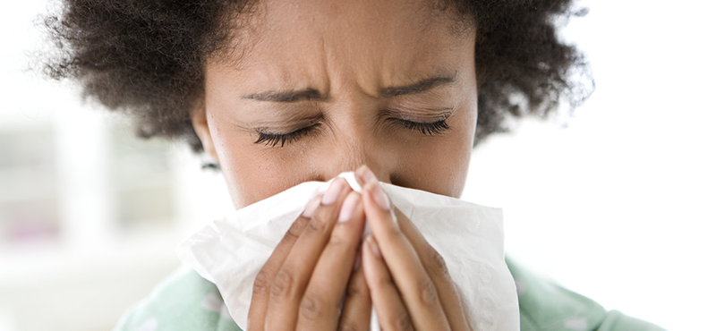 42-21529108 Woman Blowing Her Nose --- Image by © Michael A. Keller/Corbis