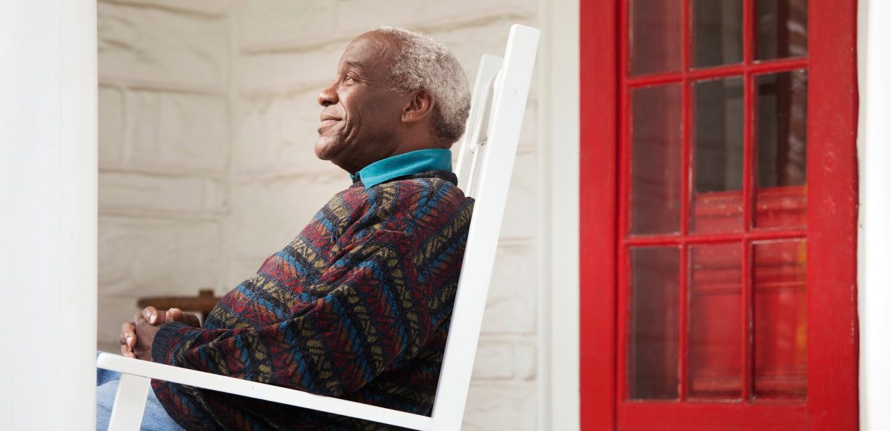 18 Oct 2012 --- Elderly man sitting on porch --- Image by © Cavan Images/Corbis