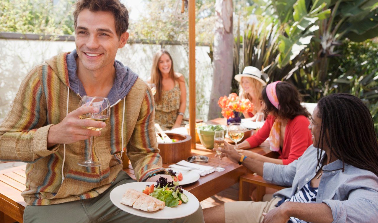 Friends dining at outdoor table --- Image by © Laura Doss/Corbis