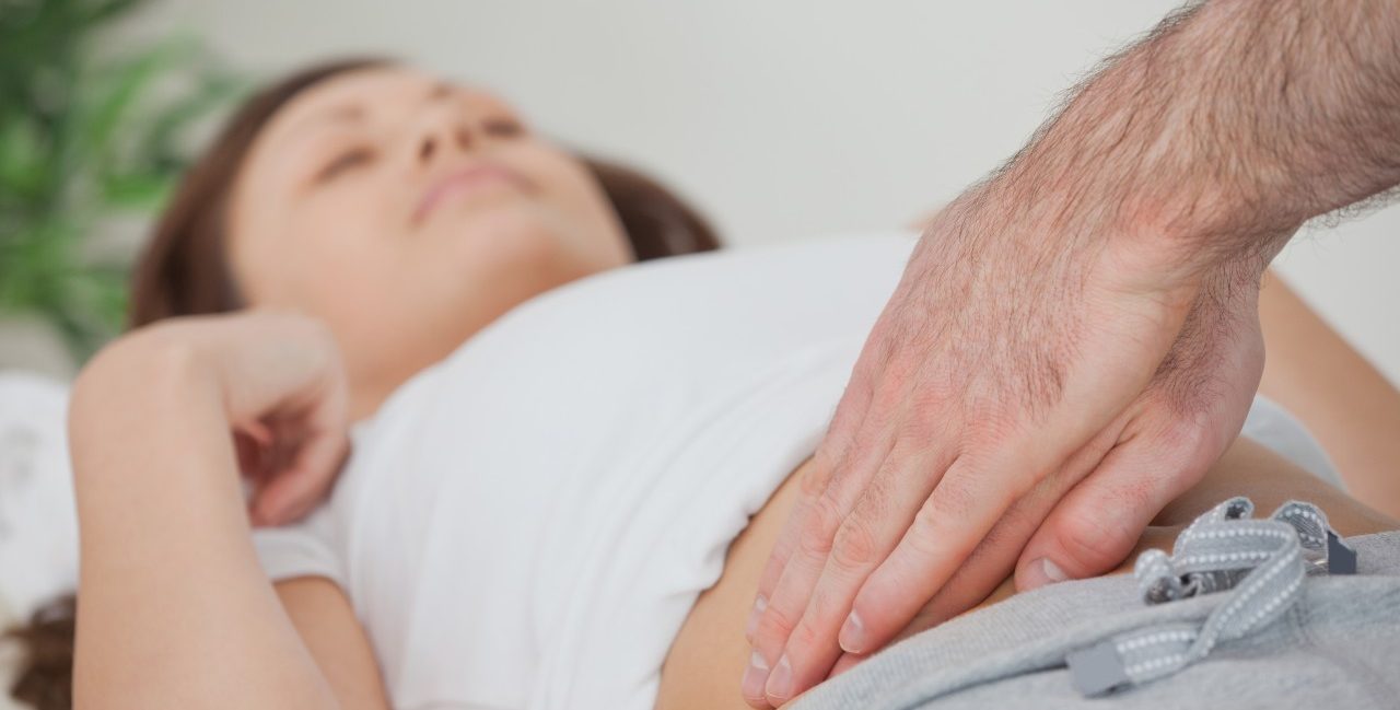 Ireland --- Doctor examining the stomach of his patient --- Image by © Wavebreak Media LTD/Wavebreak Media Ltd./Corbis