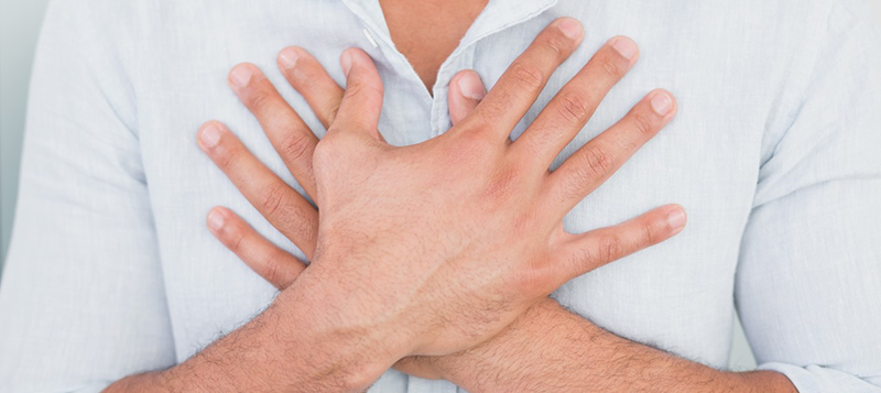 42-54995837 01 Aug 2013 --- Mid section of man with chest pain --- Image by © Wavebreak Media LTD/LightWave/Corbis