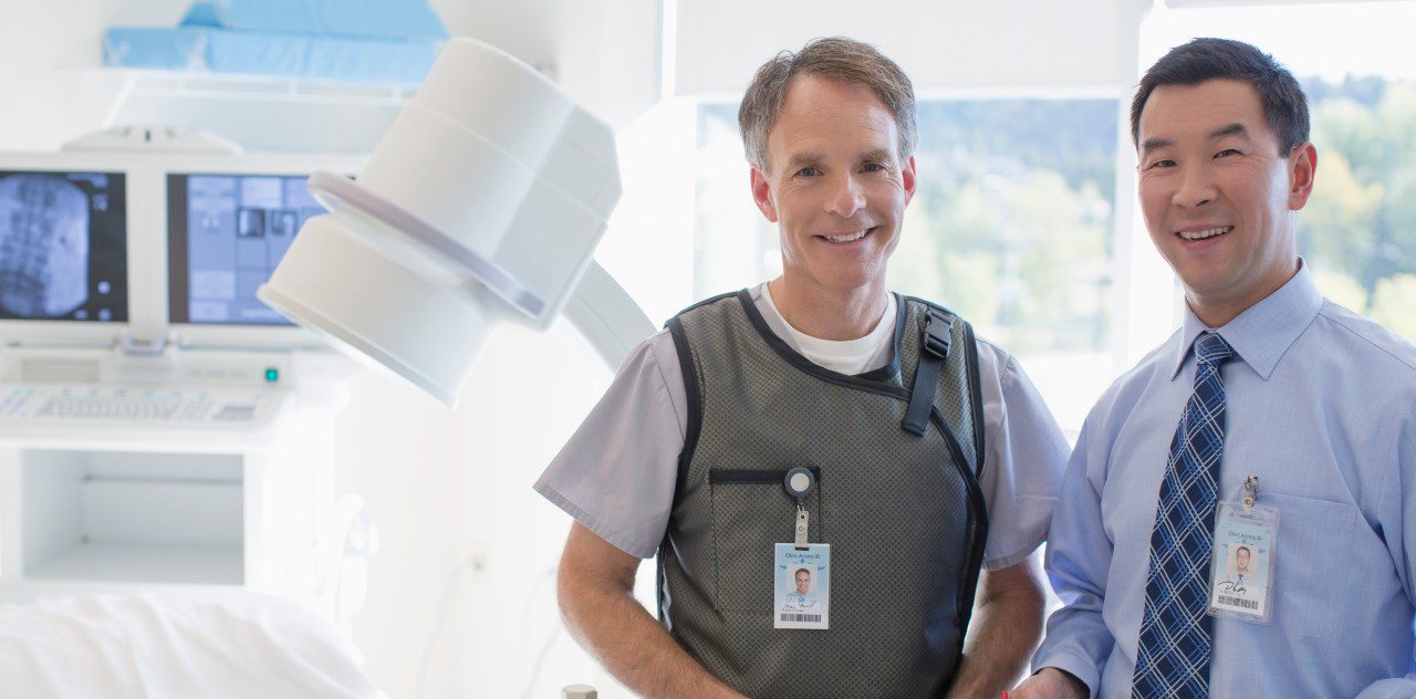 06 Sep 2012 --- Portrait of doctor and radiologist in radiology room. --- Image by © Hero Images/Corbis