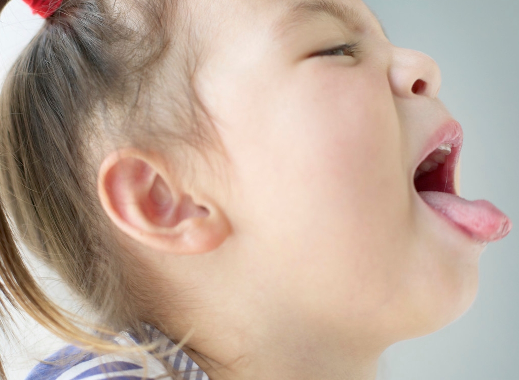 Coughing Young Girl --- Image by © Bloomimage/Corbis