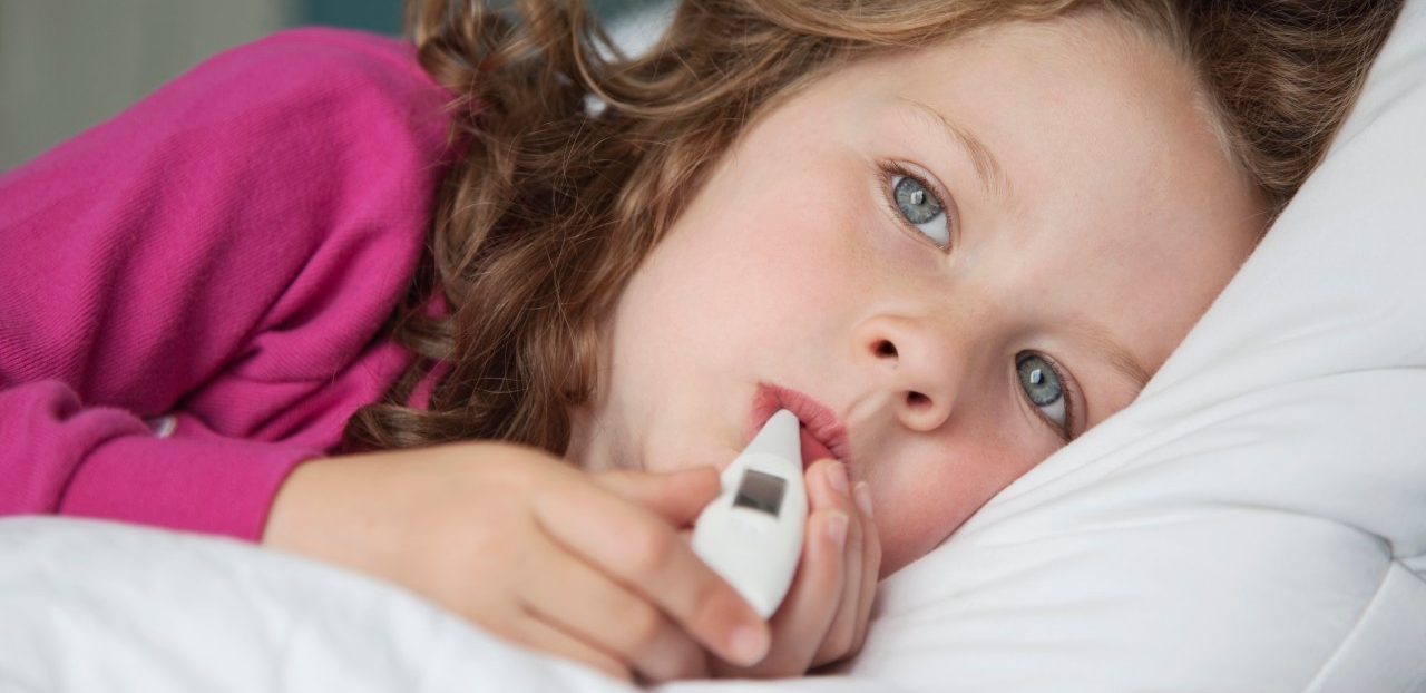 Thermometer in sick girl's mouth --- Image by © Patrick Lane Photography/Corbis