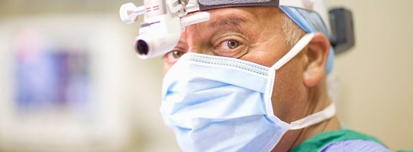 Surgeon wearing mask and headlamp --- Image by Â© Zero Creatives/cultura/Corbis