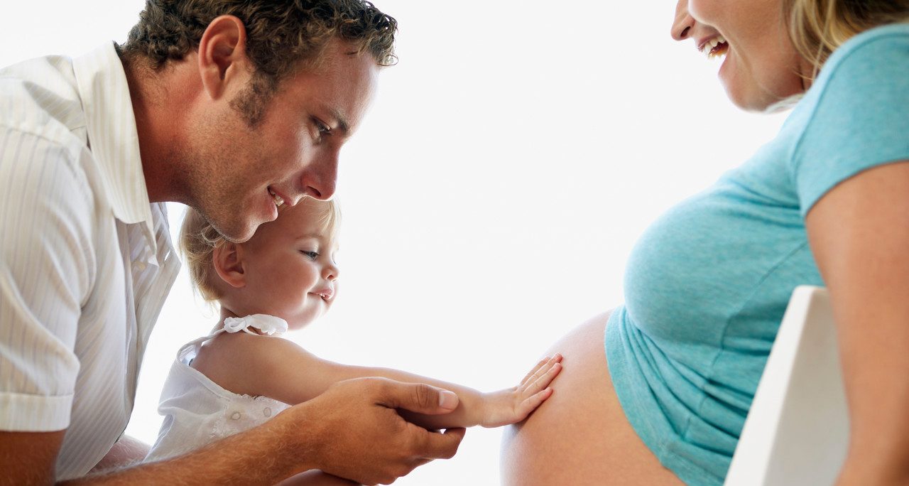 Toddler Touching Mother's Belly --- Image by © Brooke Fasani Auchincloss/Corbis