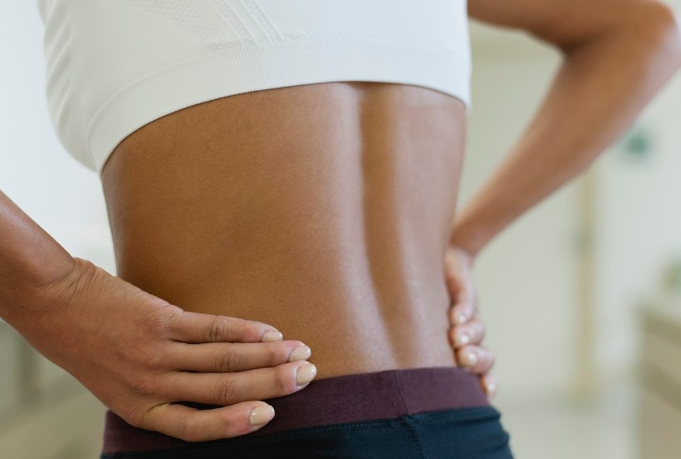 0042-11-30T00:00:00.000Z Woman with hands on lower back, mid section --- Image by © Odilon Dimier/PhotoAlto/Corbis