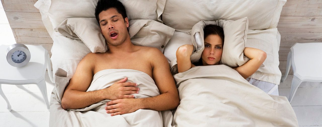 Woman Trying to Sleep While Man Snores --- Image by © Roy McMahon/Corbis