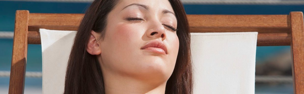 Young woman sunbathing --- Image by © Corbis