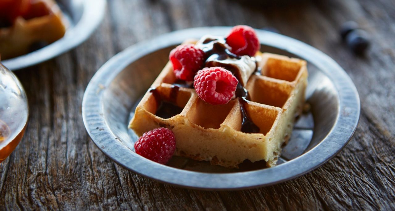 24 Sep 2014 --- Waffles topped with raspberries, whipped cream and chocolate. --- Image by © Lew Robertson/Corbis