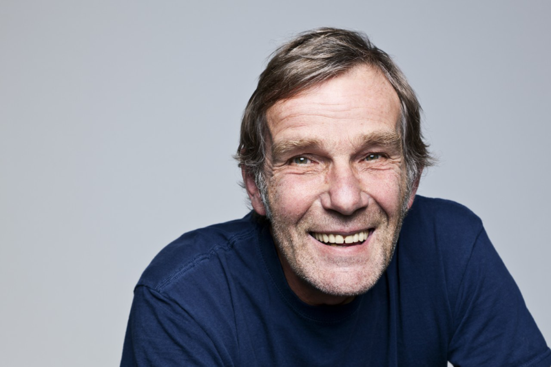 Studio portrait of senior man smiling --- Image by © Norbert Schaefer/Corbis