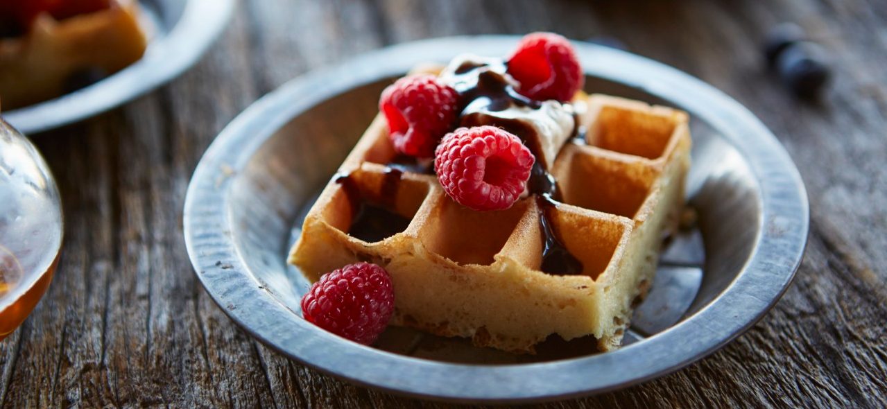 24 Sep 2014 --- Waffles topped with raspberries, whipped cream and chocolate. --- Image by © Lew Robertson/Corbis