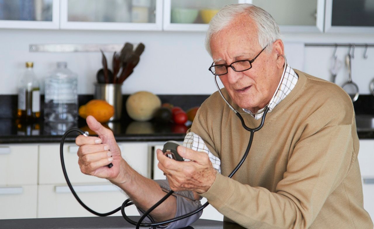 16 Dec 2011 --- Caucasian man taking his own blood pressure --- Image by © Rolf Bruderer/Blend Images/Corbis
