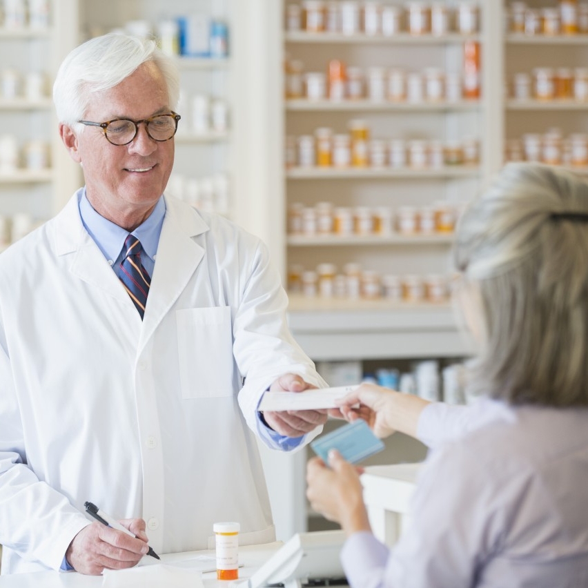 19 May 2013, Houston, Texas, USA --- Caucasian pharmacist giving prescription to customer --- Image by © Terry Vine/Blend Images/Corbis