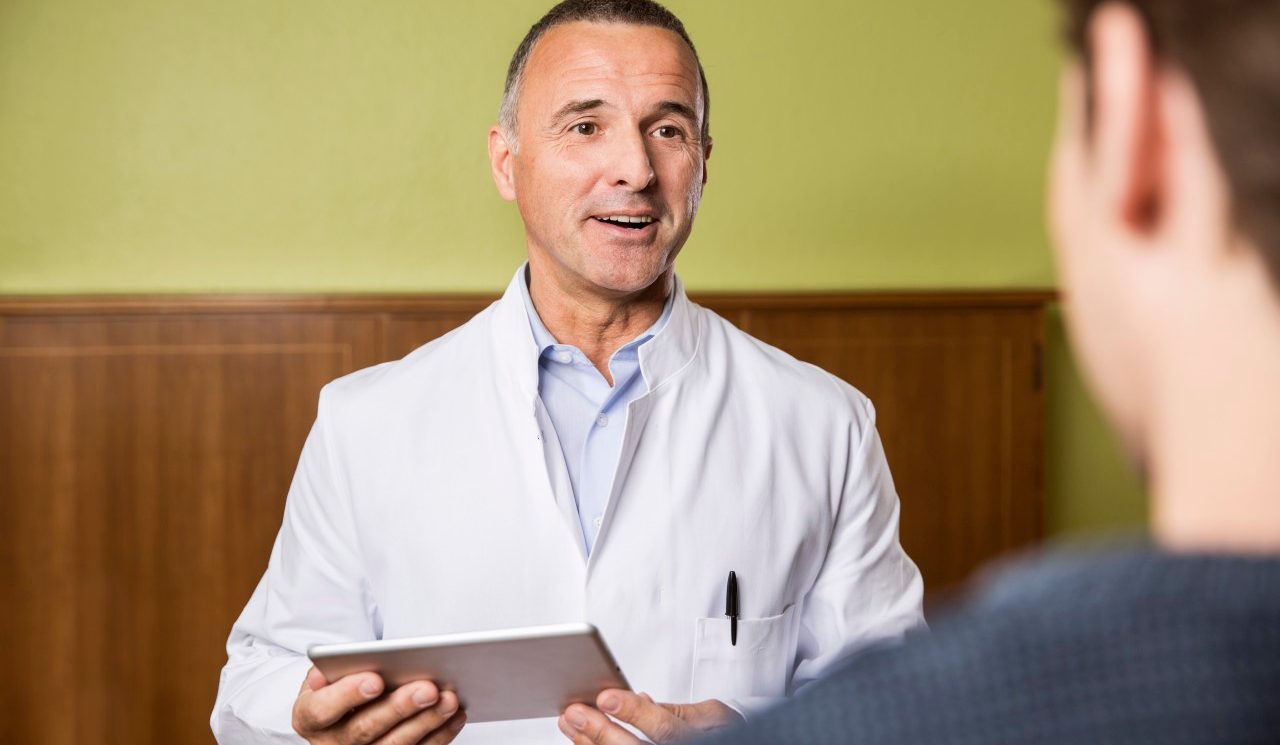 03 Apr 2014 --- Doctor with digital tablet talking to patient --- Image by © Mareen Fischinger/Westend61/Corbis