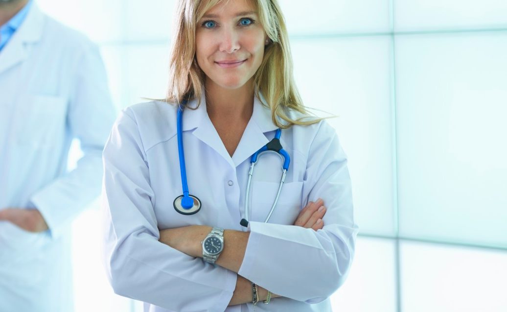 31 Oct 2014 --- Doctors posing against backlit wall panel --- Image by © Corbis