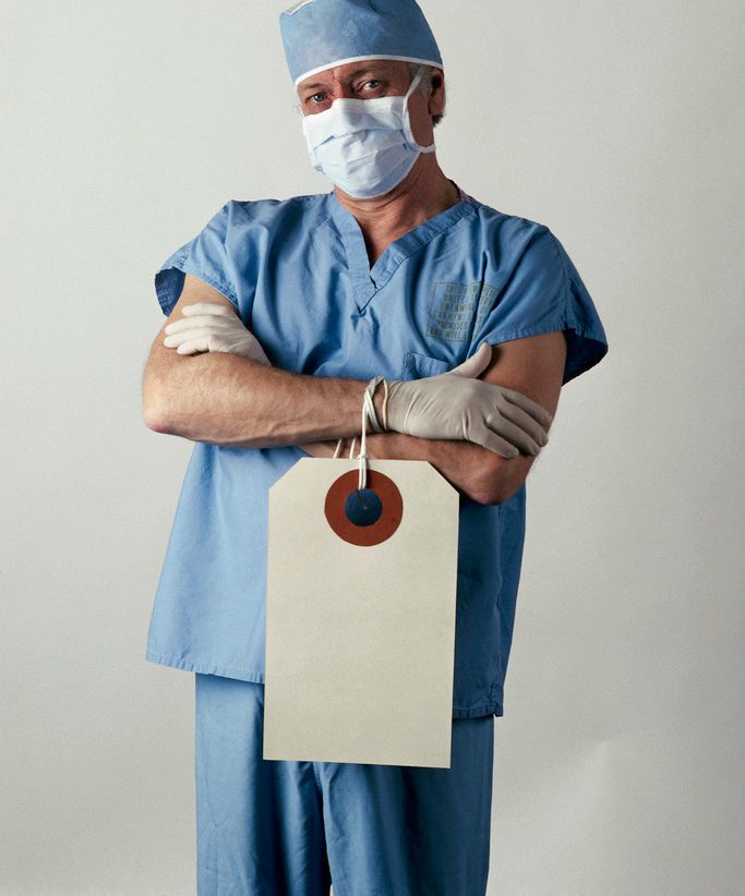 Doctor Wearing a Tag --- Image by © Larry Mulvehill/Corbis