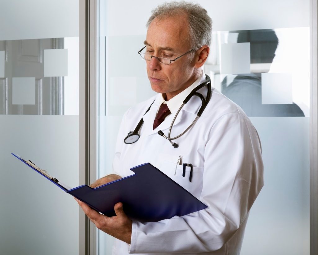 0042-11-30T06:00:00.000Z Doctor reading a chart --- Image by © David Sutherland/Corbis