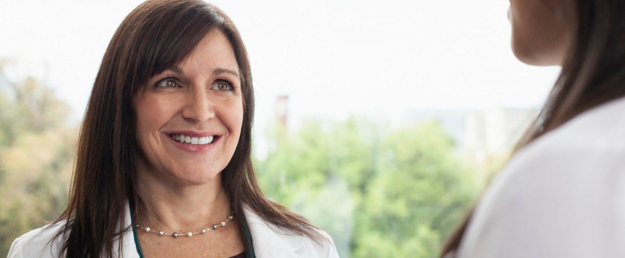 Smiling female doctor --- Image by Â© Samantha Mitchell/Corbis