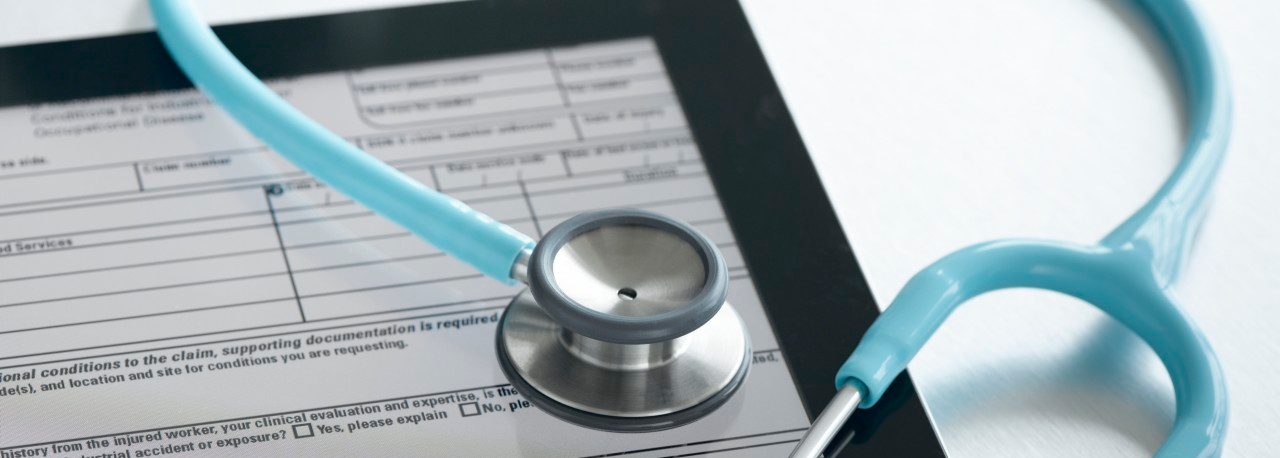 Studio shot of stethoscope and digital tablet with medical form --- Image by © Pulse/Corbis