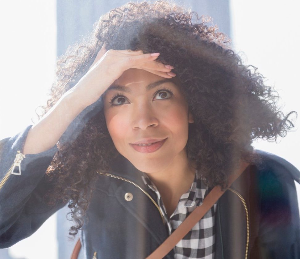 16 Jan 2015, Jersey City, New Jersey, USA --- Mixed race woman window shopping --- Image by © Jamie Grill/Blend Images/Corbis