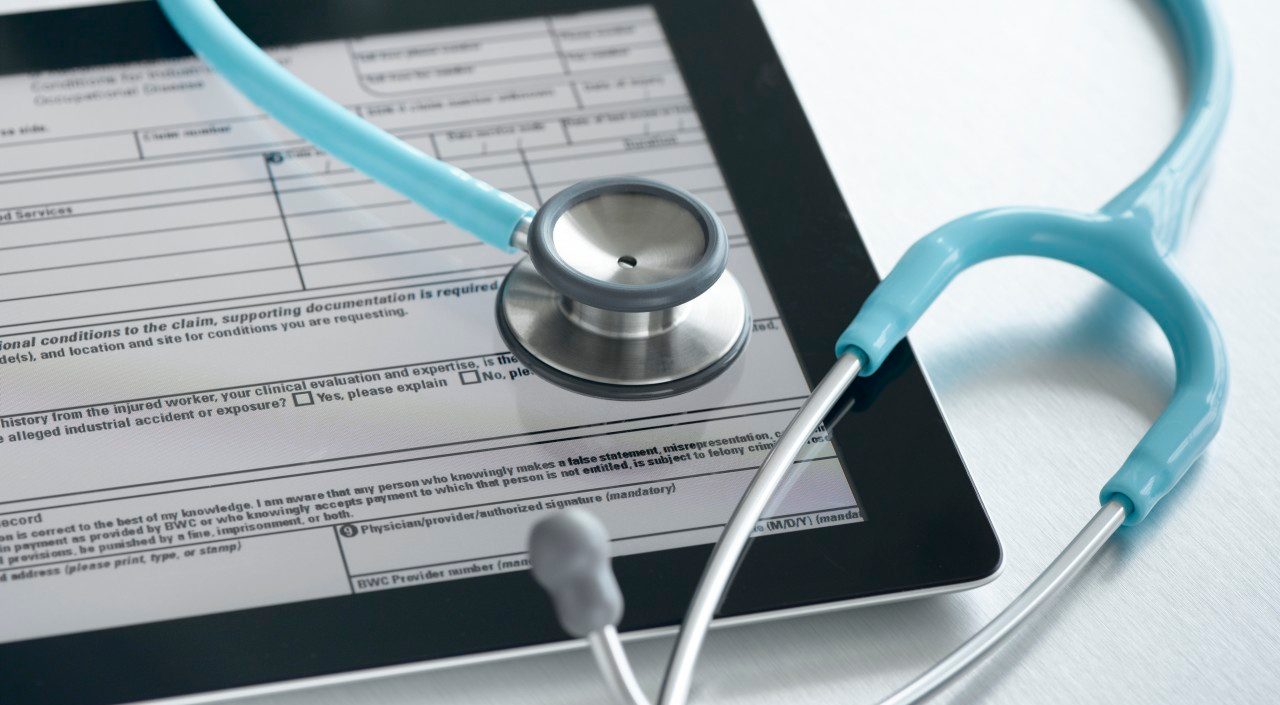 Studio shot of stethoscope and digital tablet with medical form --- Image by © Pulse/Corbis