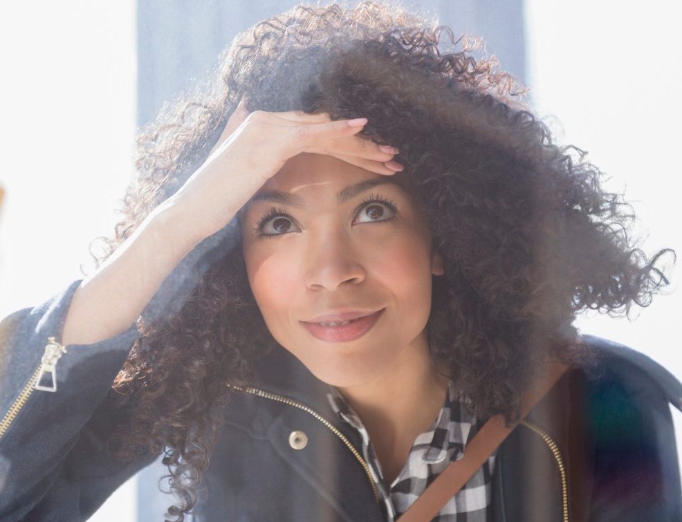 16 Jan 2015, Jersey City, New Jersey, USA --- Mixed race woman window shopping --- Image by © Jamie Grill/Blend Images/Corbis