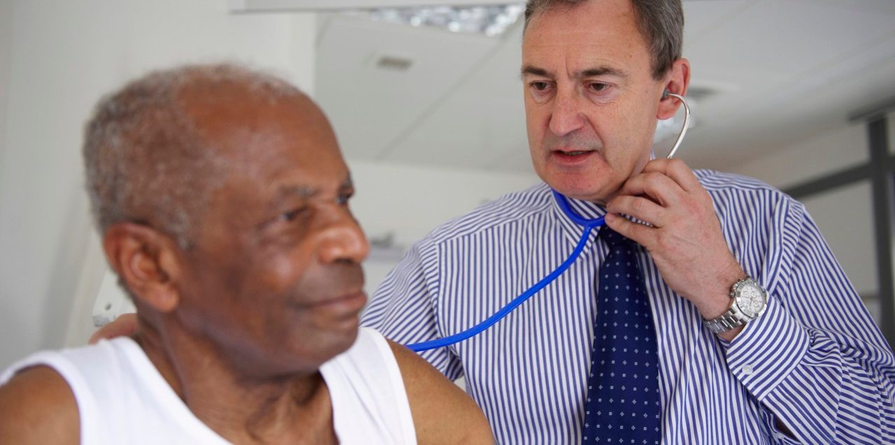 0042-11-30T00:00:00.000Z Doctor with stethoscope with elderly man --- Image by © Janie Airey/cultura/Corbis