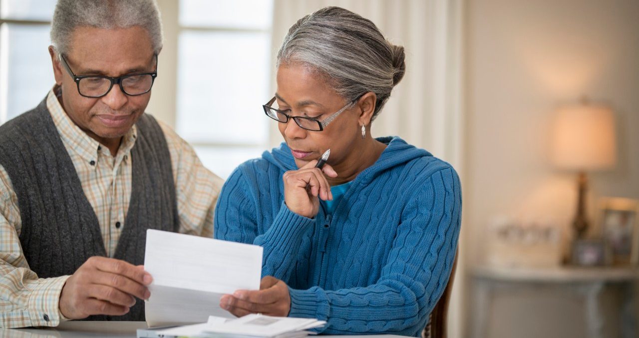 21 Jan 2014 --- Senior African American couple paying bills --- Image by © Terry Vine/Blend Images/Corbis